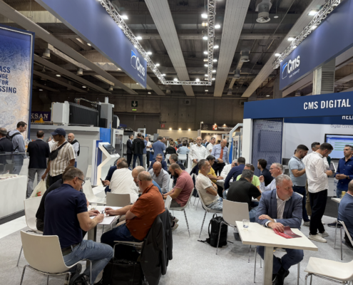 men sitting at tables at marmomc 2025